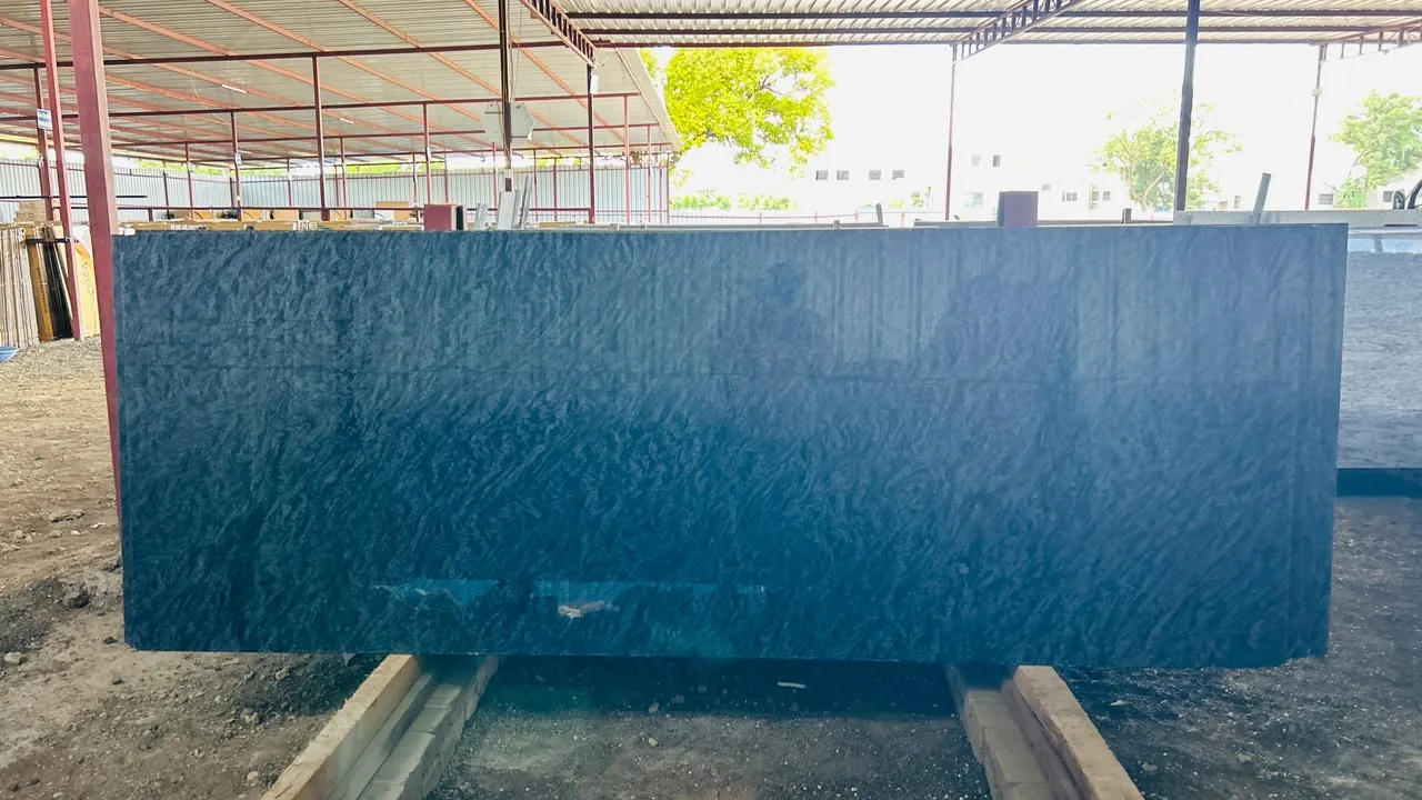 Full blue-grey granite slab displayed on timber supports in the covered Paras Home Decor yard