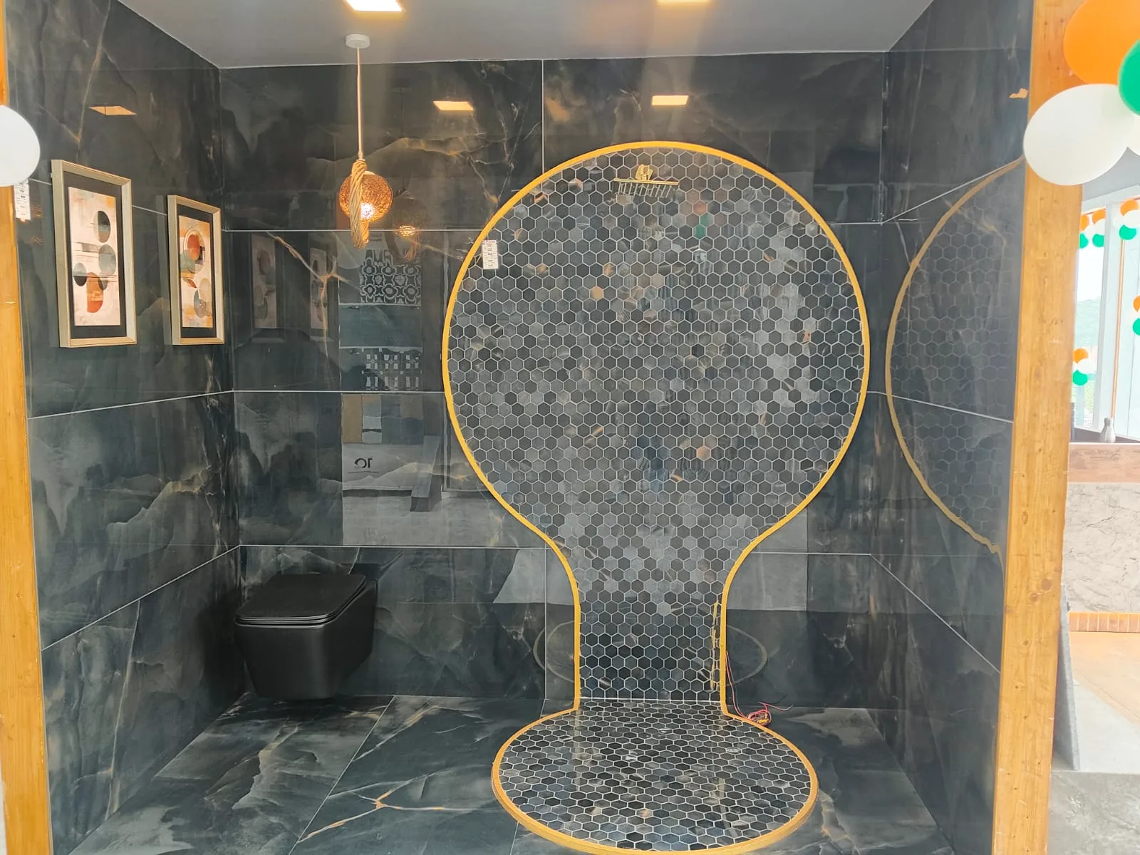 Dark onyx-look tile bathroom bay with hexagon mosaic shower area and matte black WC