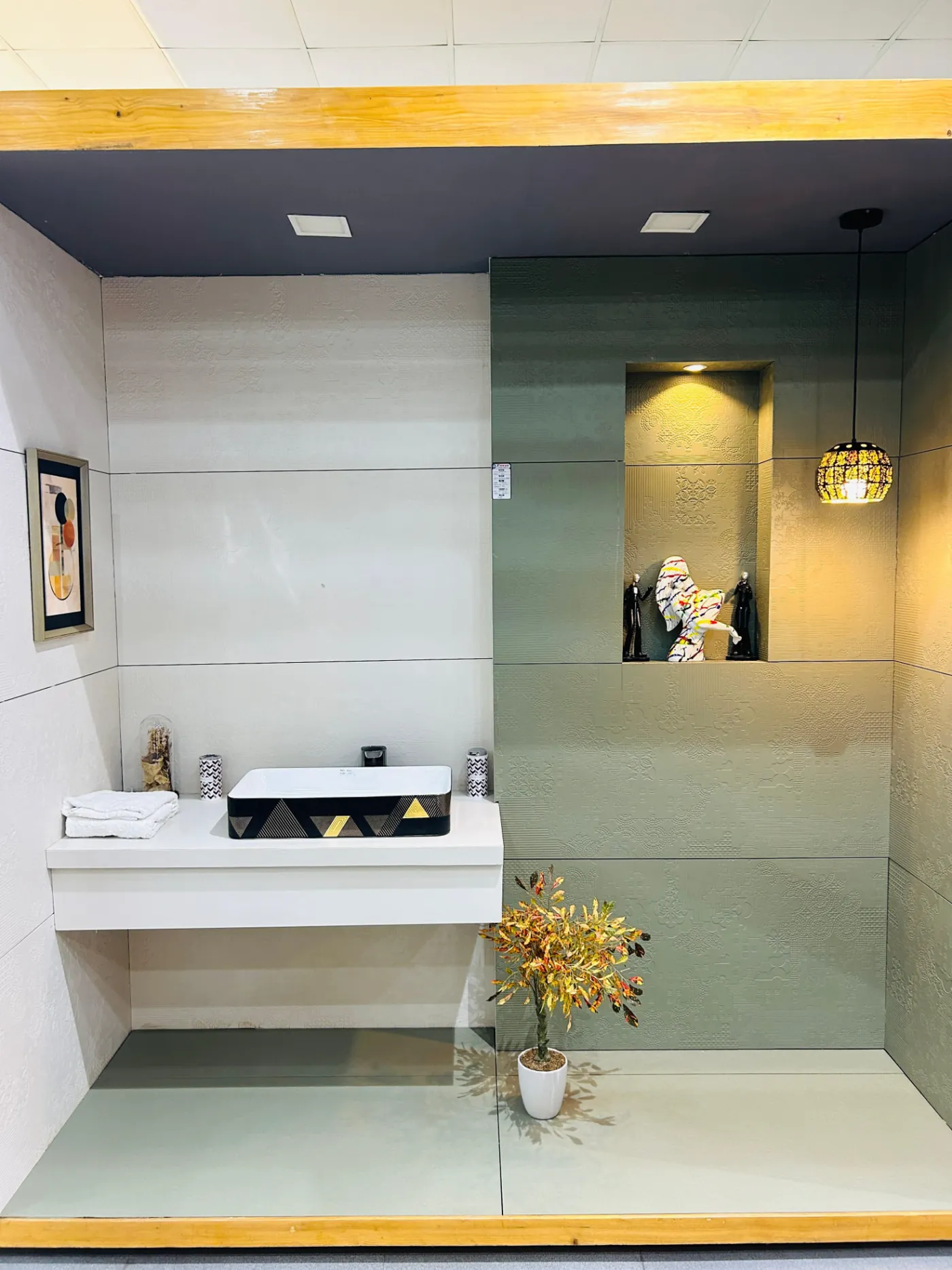 Minimal bathroom mock-up bay with counter-top basin and textured wall tiles