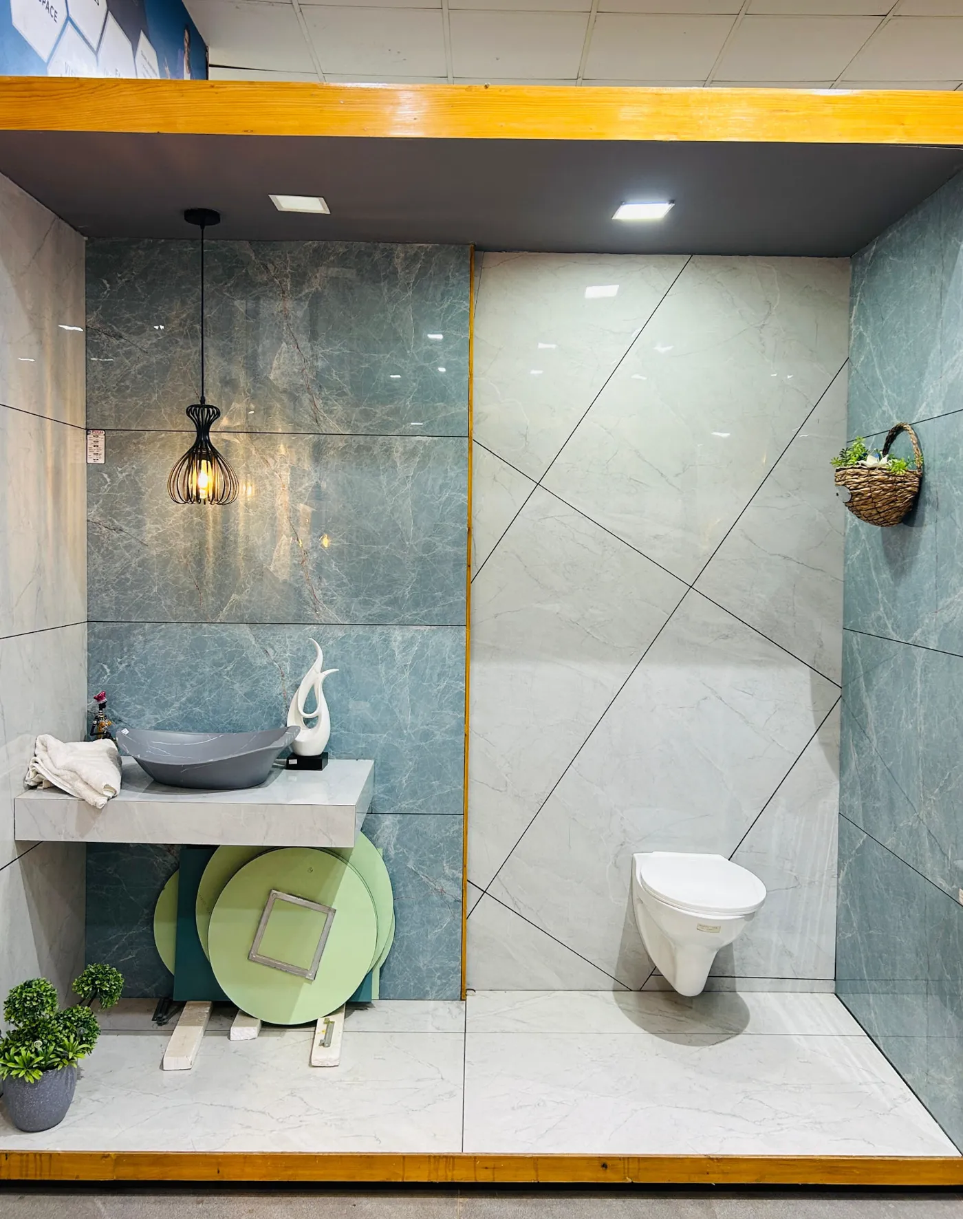 Teal and white marble-look tile bathroom bay with wall-hung WC and vessel basin