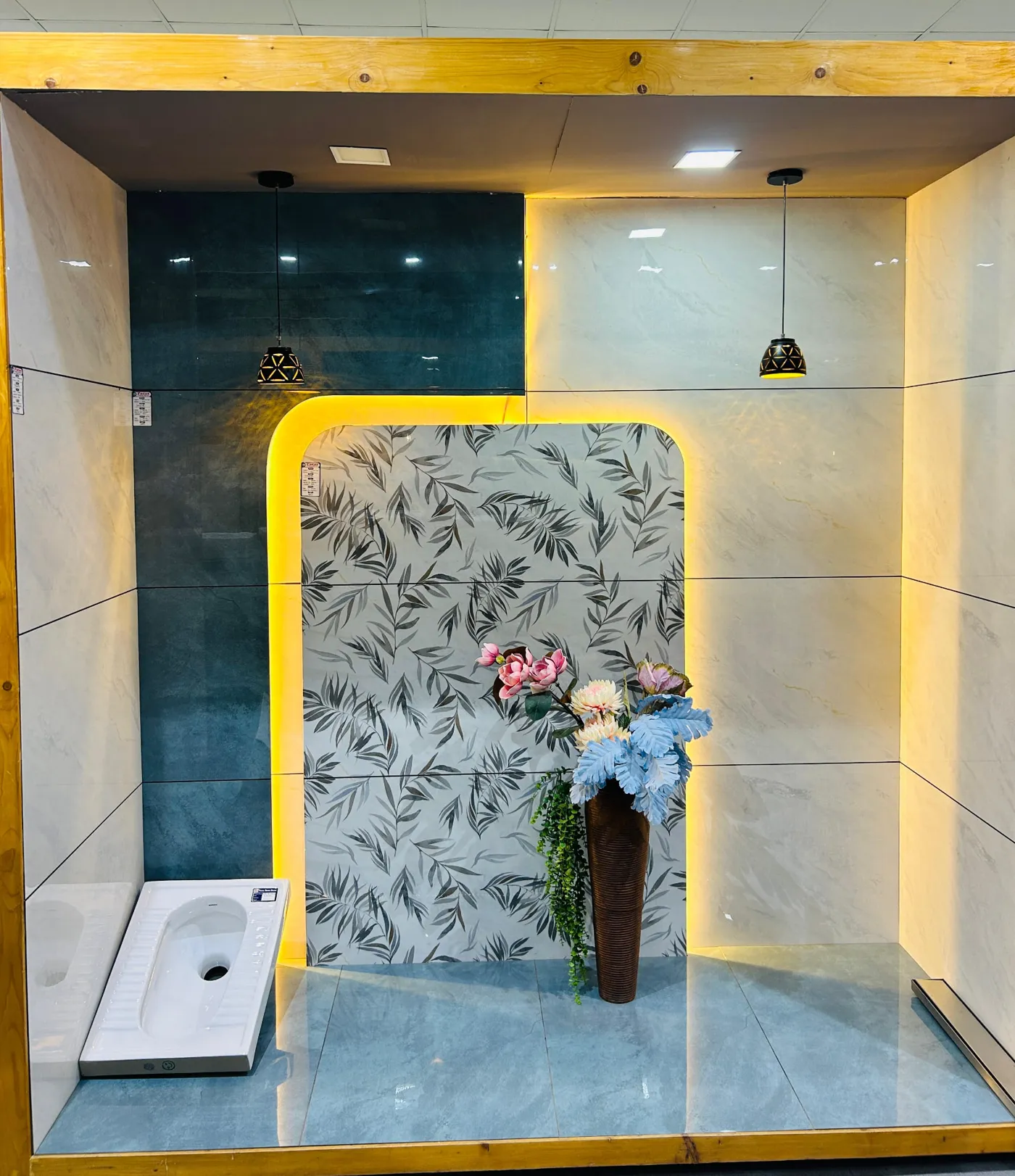 Leaf-pattern feature wall tile bay with backlit arch and blue floor tiles
