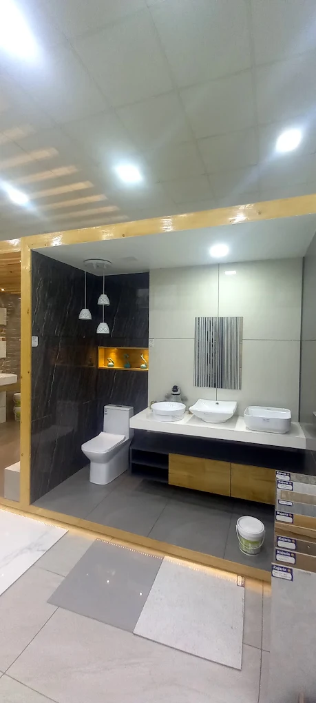 Modern bathroom display with dark marble-look tiles and twin basins