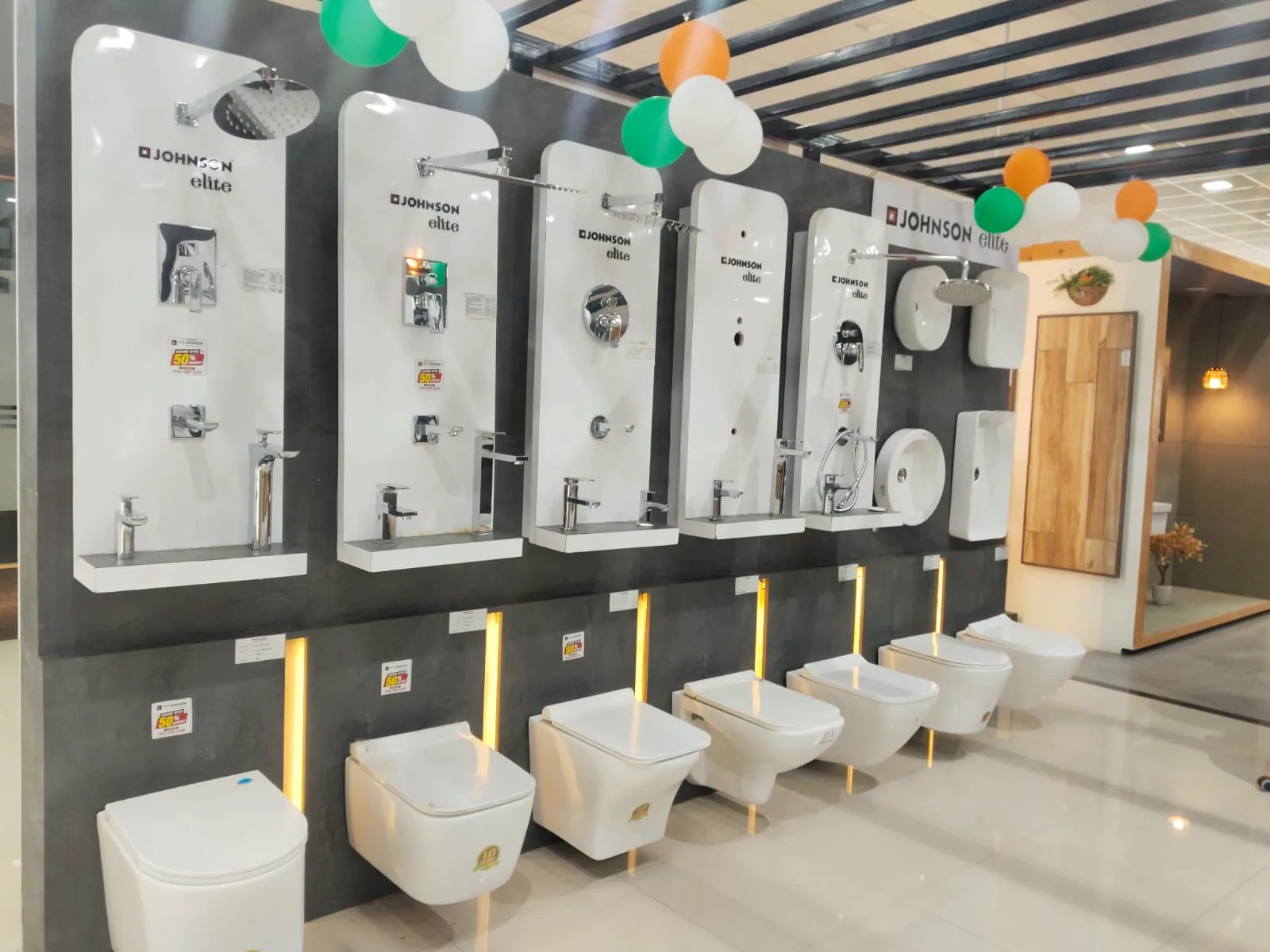 Row of Johnson Elite wall-hung water closets and basins on display